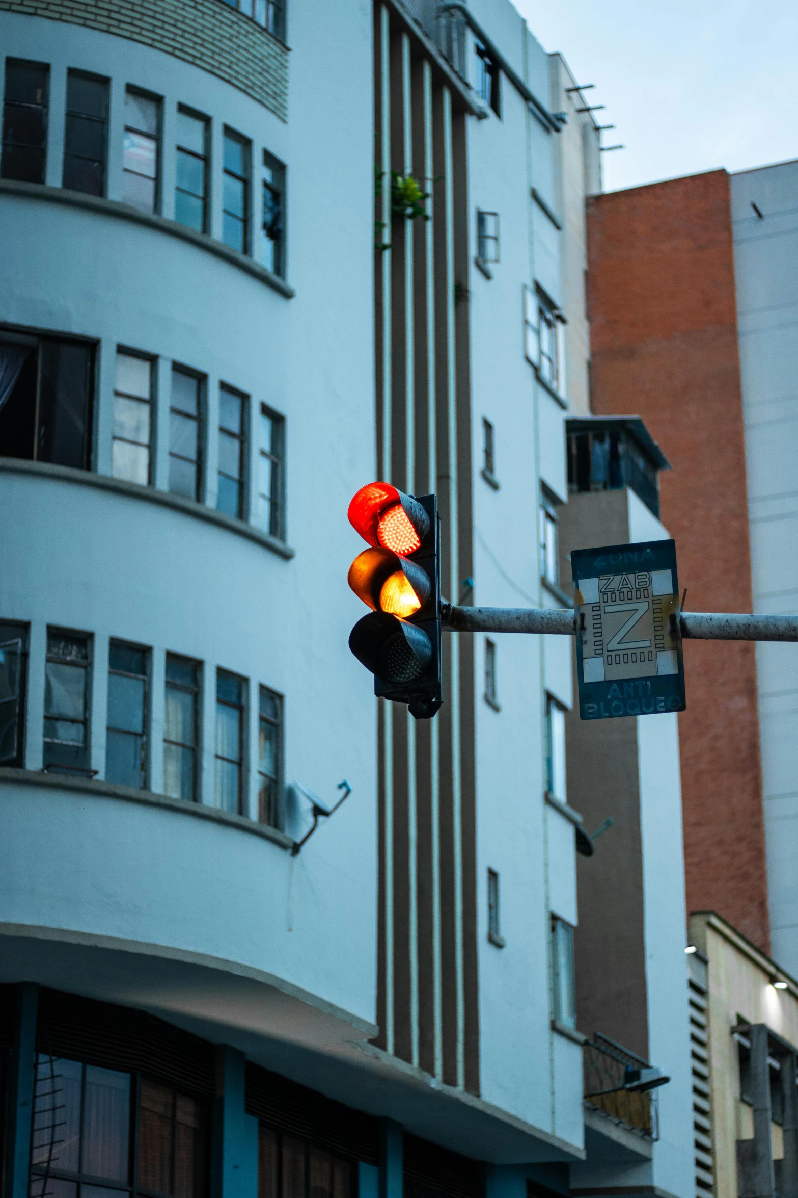 a traffic light next to some buildings and a blue building