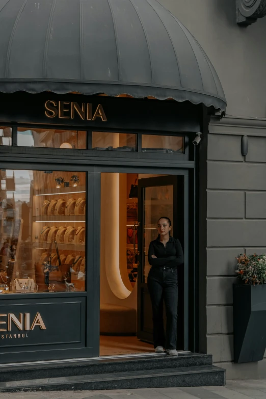 the woman is waiting outside her store for someone to buy them