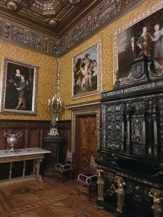 a large room filled with paintings next to wooden table