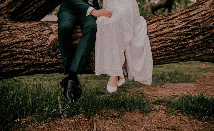 a couple is sitting in the middle of a tree