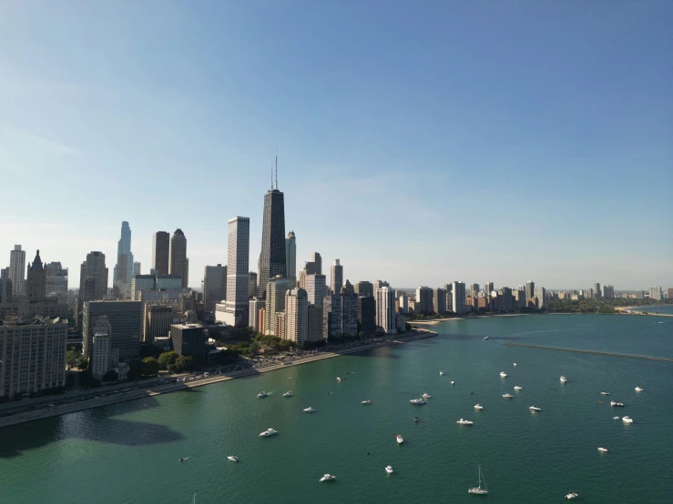 an aerial view of a city with ships in the ocean