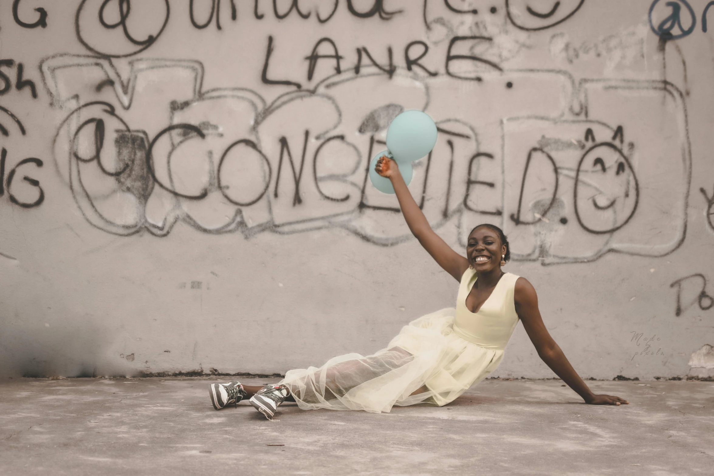 a woman sitting on the ground with a frisbee