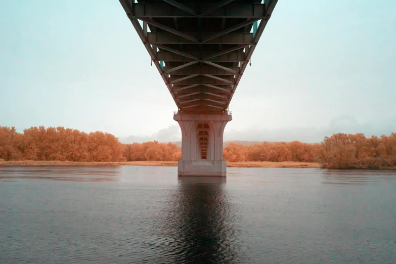 the reflection of the bridge shows water below