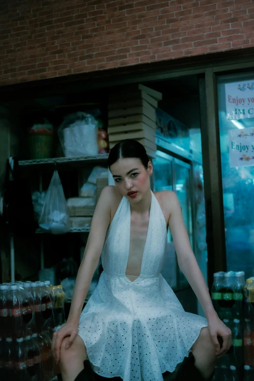 a woman dressed in white is posing for a po