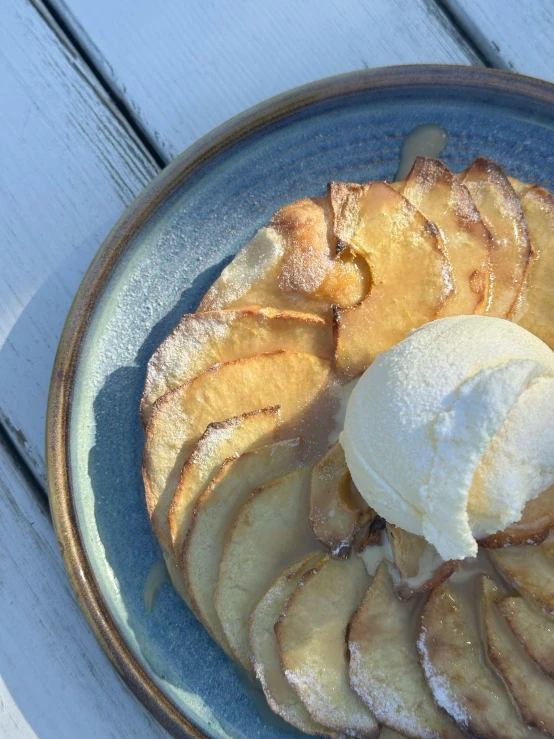 a blue plate of bananas and ice cream on top