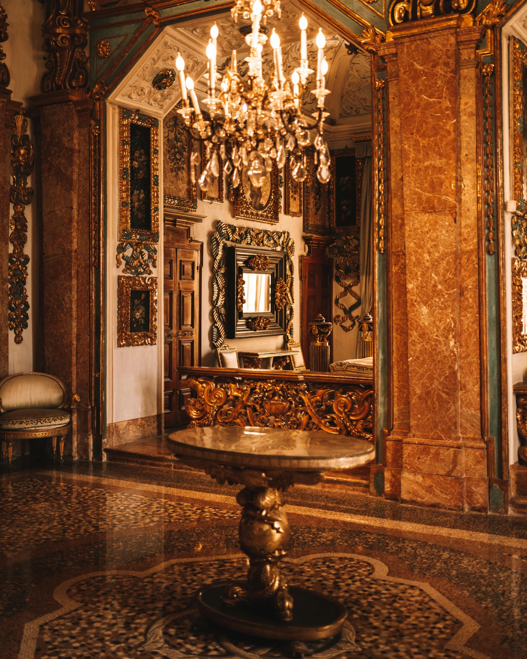 a large chandelier hangs from the ceiling in a ornate room