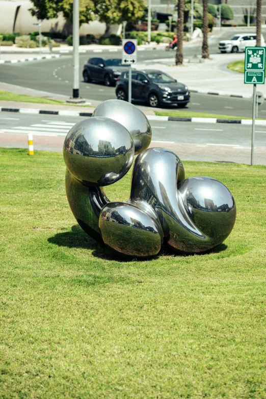 large steel sculptures on the grass in a park