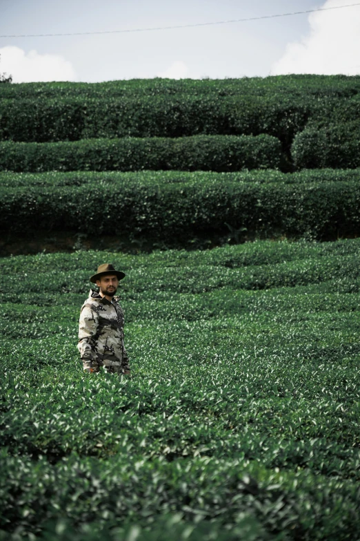 a man standing in a field of grass