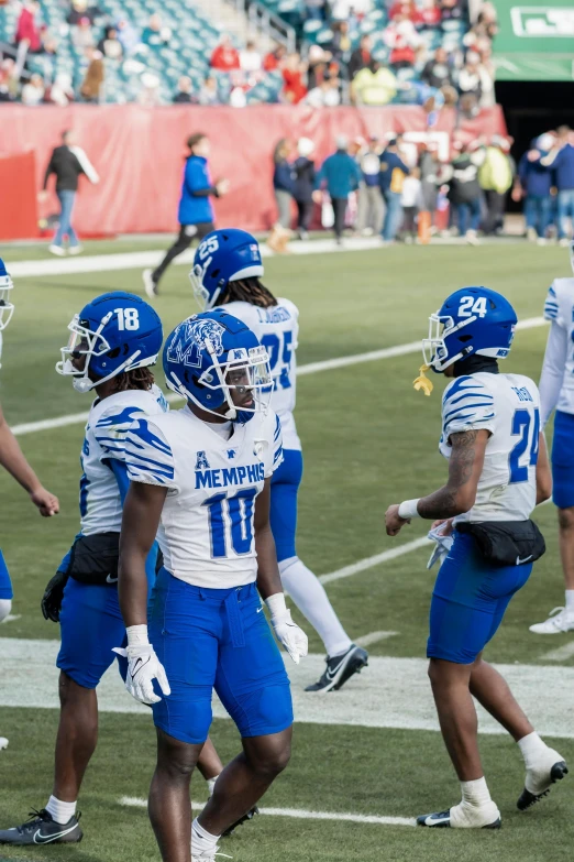 a group of football players are standing together