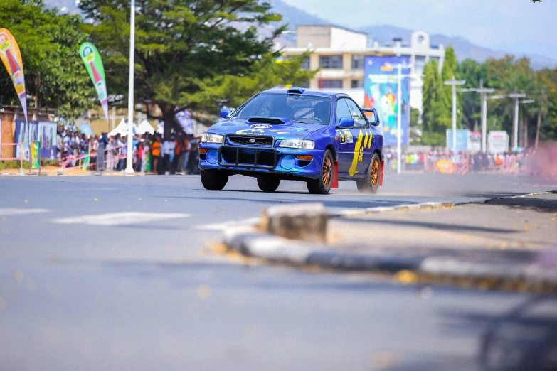 an automobile racing down the street with spectators watching