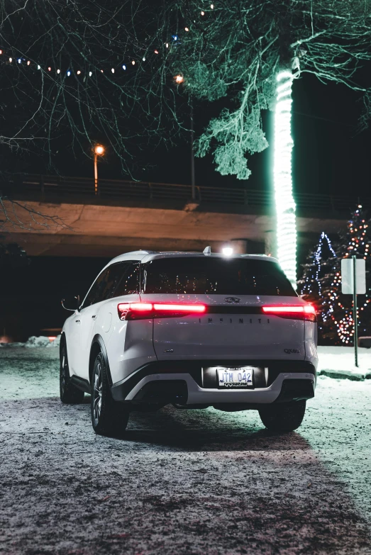 a suv parked near a street sign with a tree