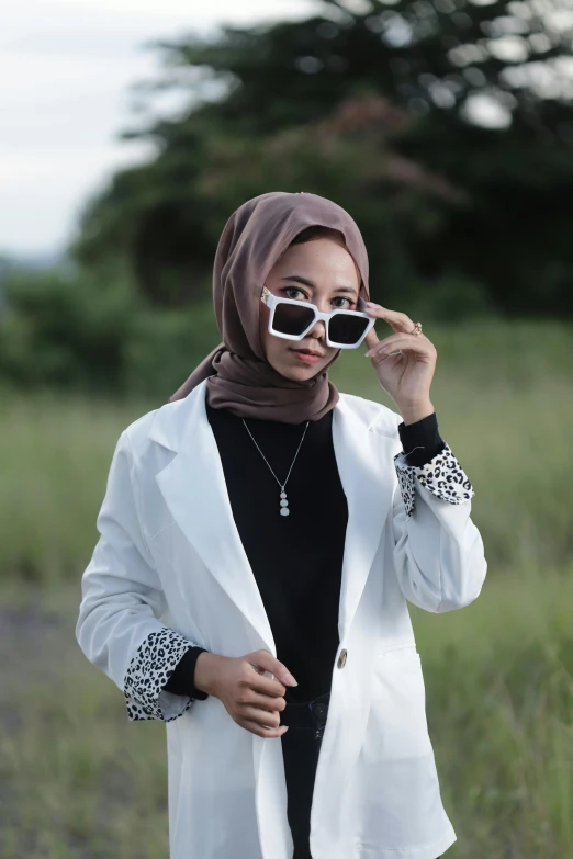 a woman wearing sunglasses and a scarf