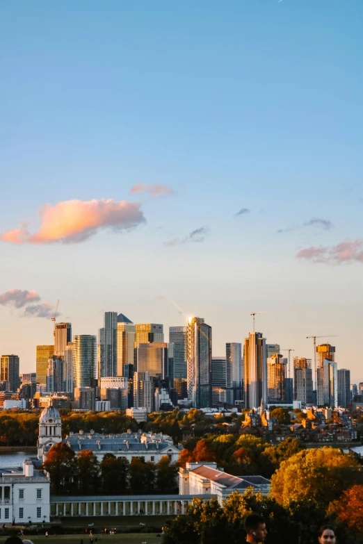 a city skyline with buildings and an airplane flying over it