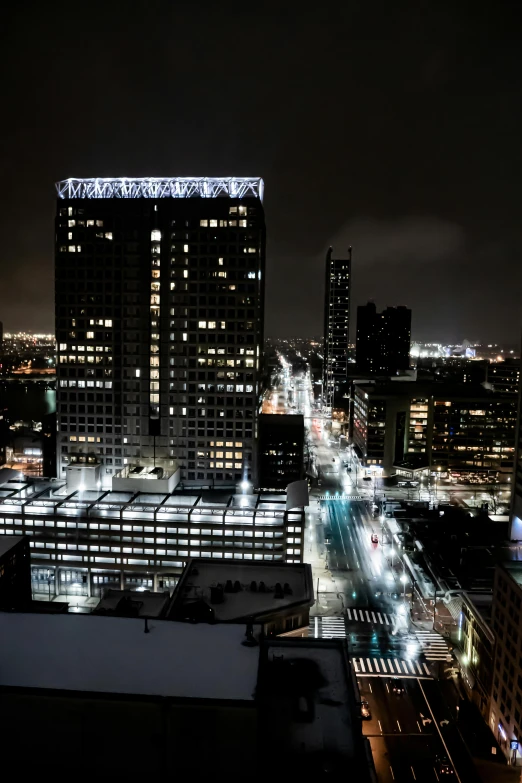 a night view of buildings from above with the lights reflecting off