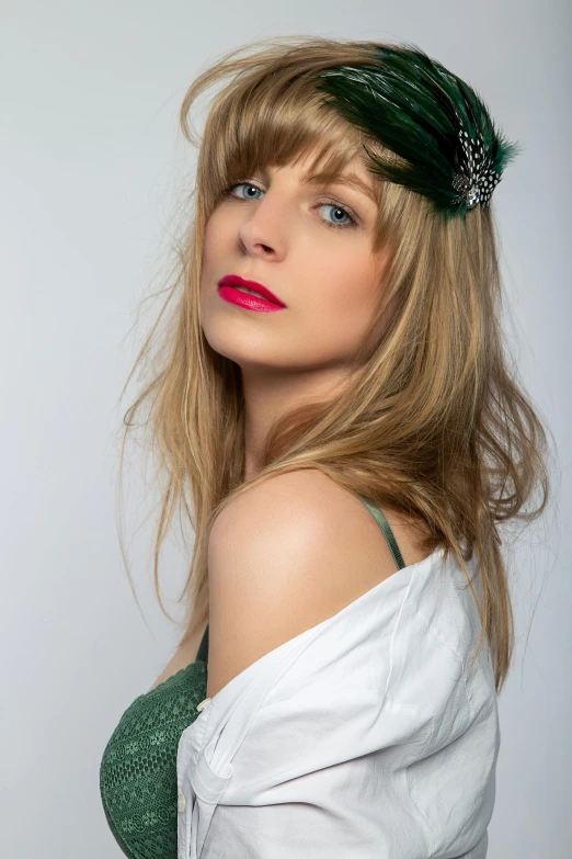 a women with a green hair band and a white blouse