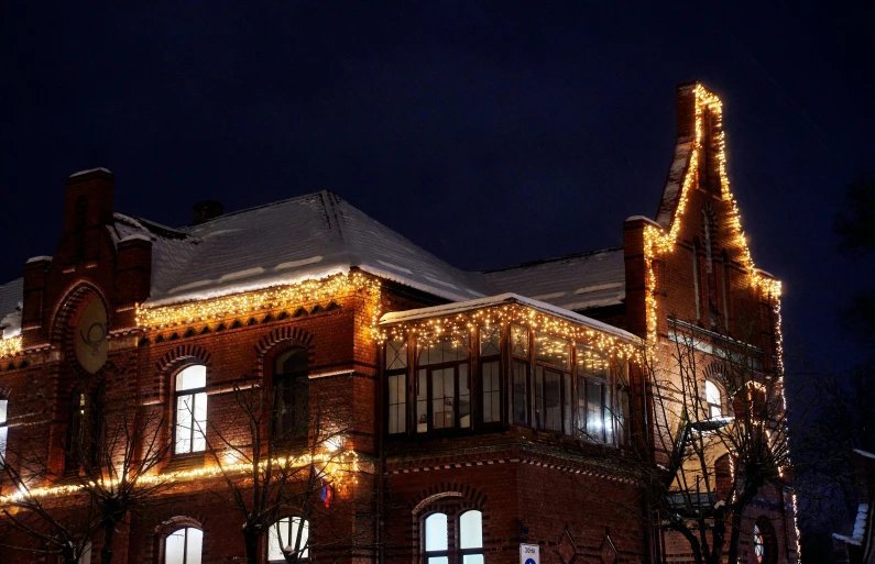 a building covered with christmas lights and decorations