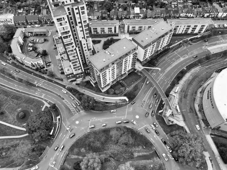 an aerial view of a city with cars, street lights and some buildings