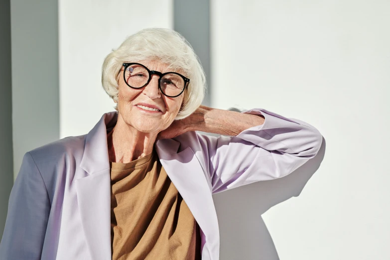 an elderly woman poses in her blue and purple attire