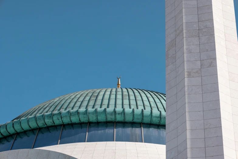 the top of the dome of a building against a clear sky