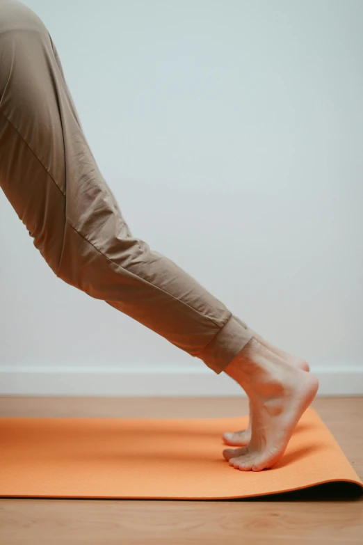 a person does h ups while standing on a yoga mat