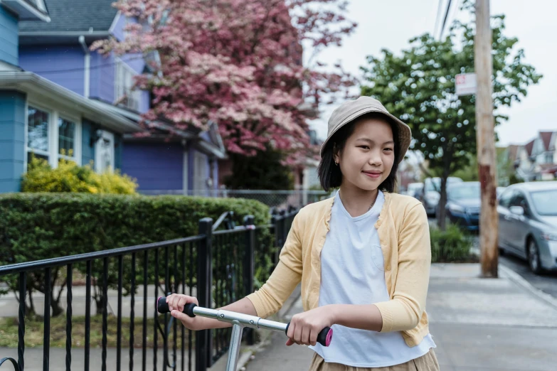 a woman is leaning on her bicycle on the street