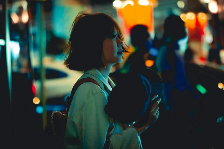 woman holding back her cellphone with a lot of traffic behind her