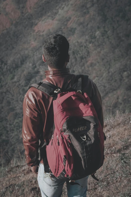 the man has backpacks for hiking in the mountains