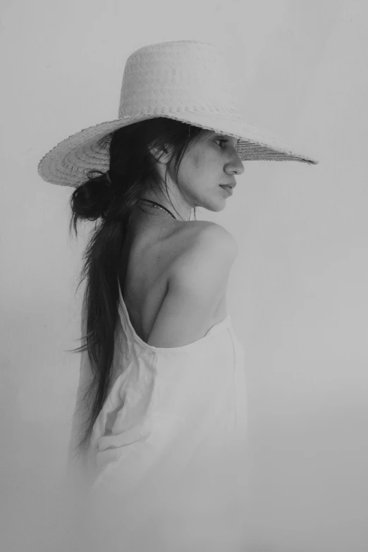 black and white po of woman with hat on