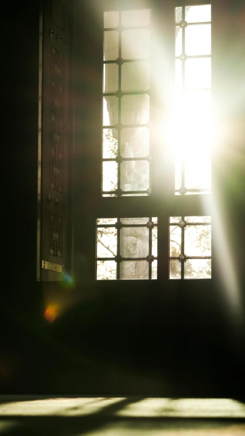 a large window with the sun shining through it