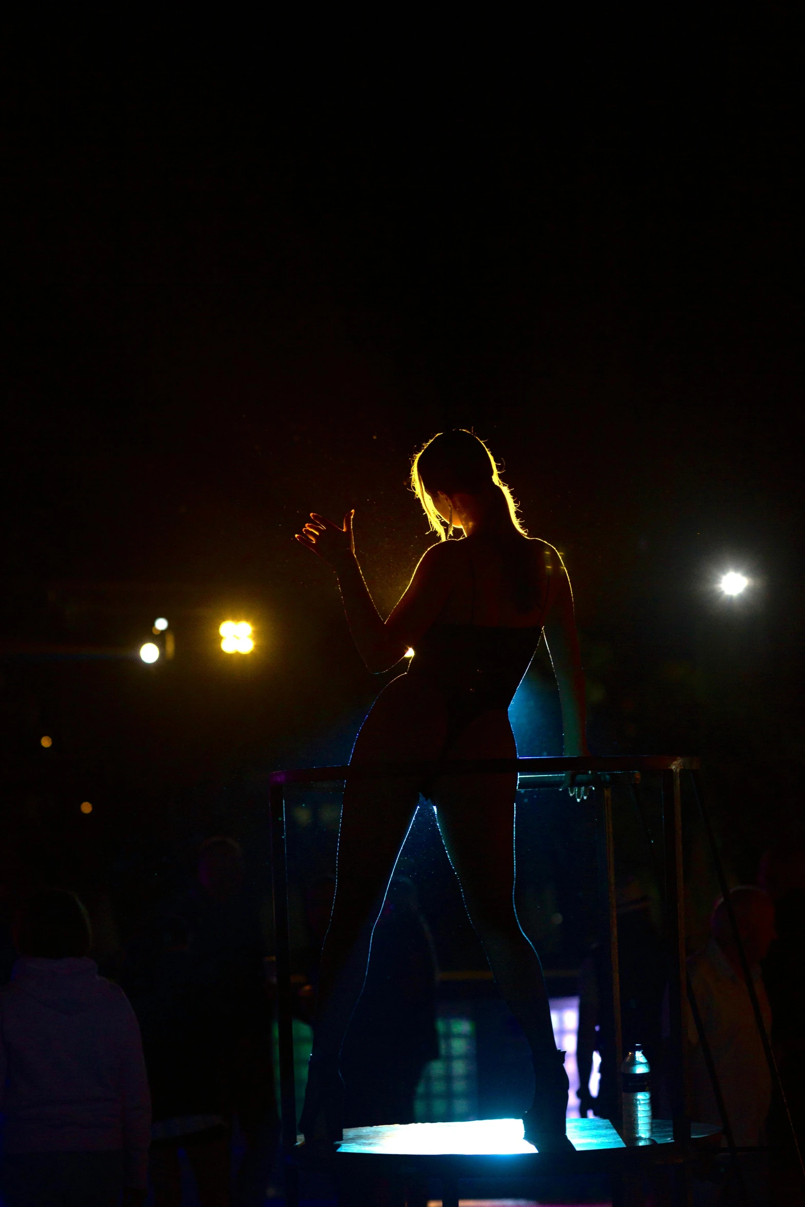 a person standing on stage in the dark