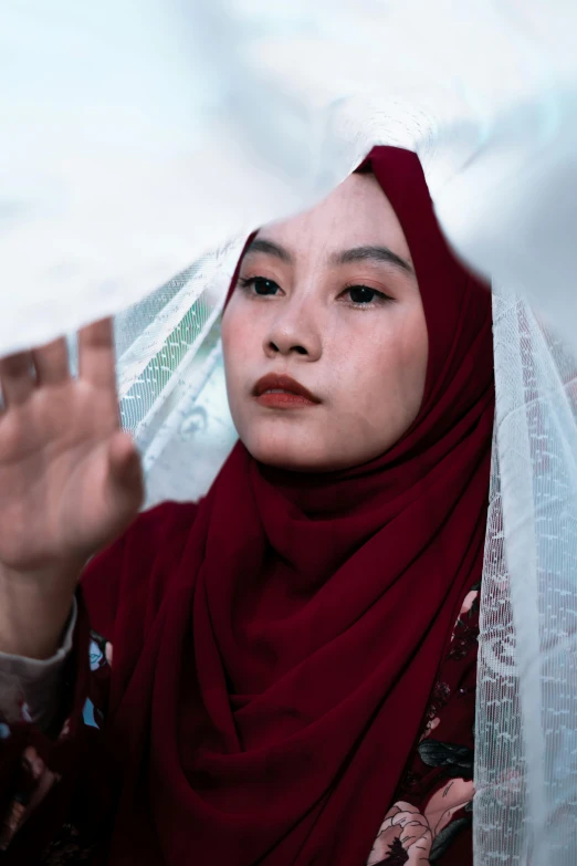 a woman with a red scarf around her head