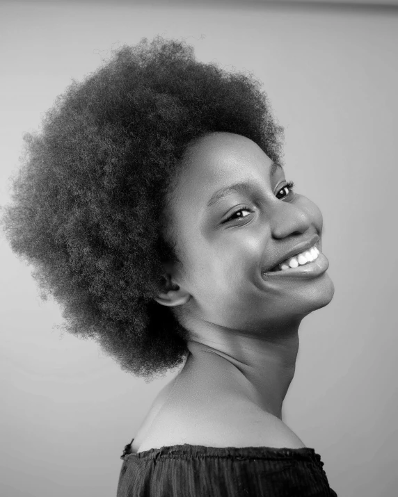 a black and white po of a woman with an afro