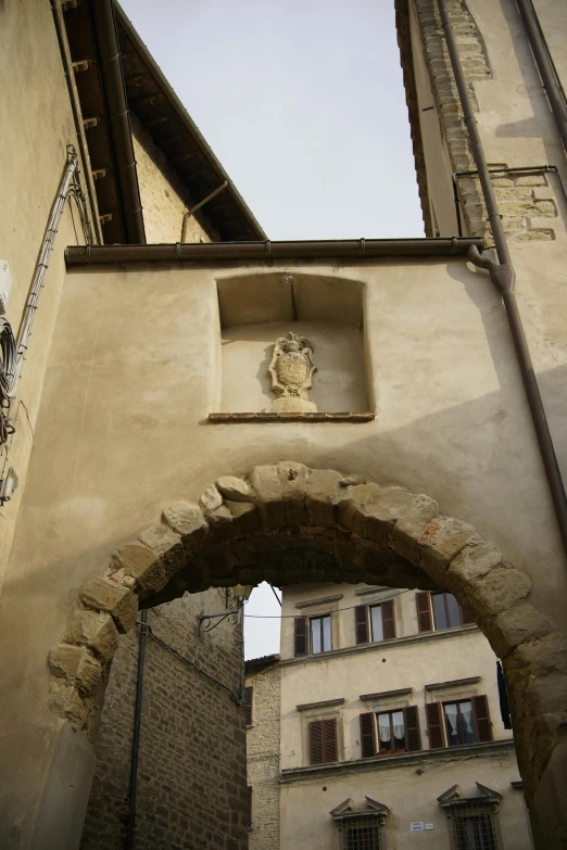 an archway way with a head on the wall