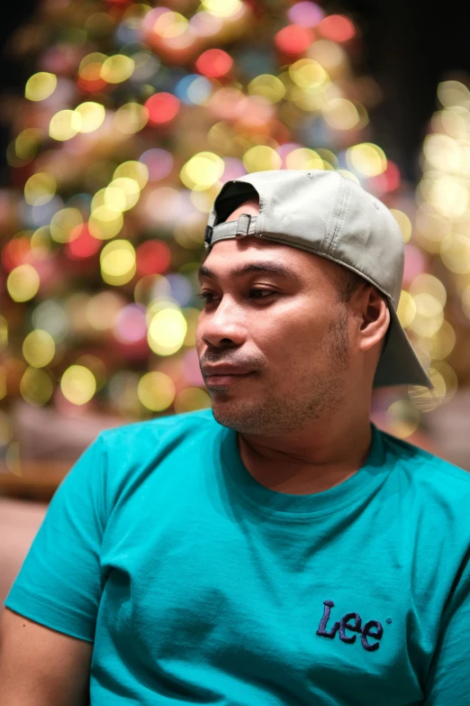 a man looking away while wearing a hat