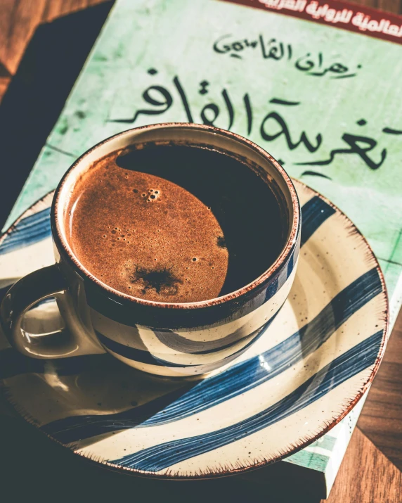 a cup of chocolate tea sits on a table