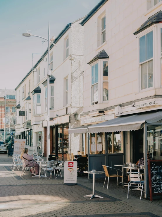 outdoor seating on a street lined with buildings