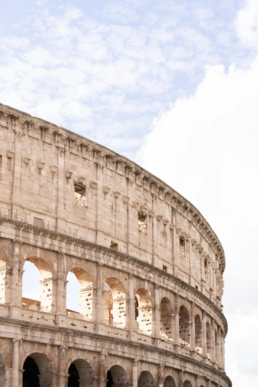 the roman collisure against a cloudy blue sky