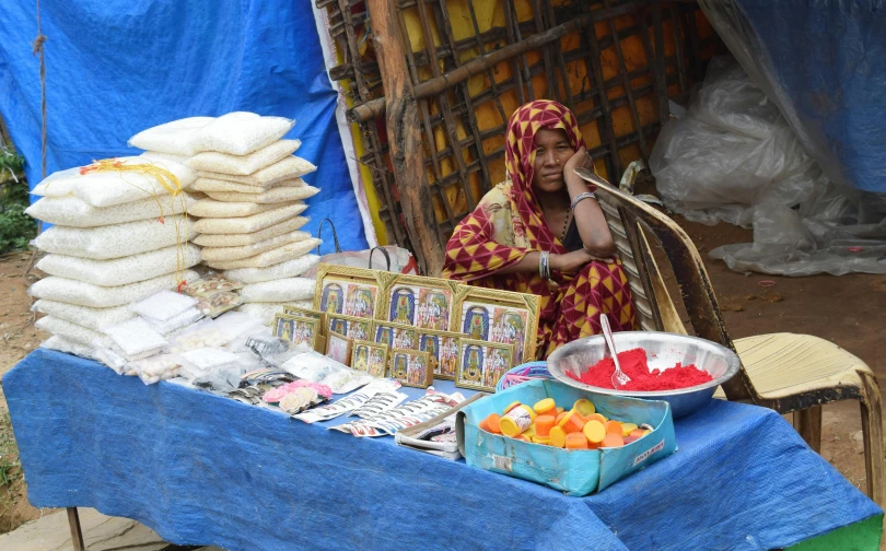 an outdoor vendor is selling various products including fruit