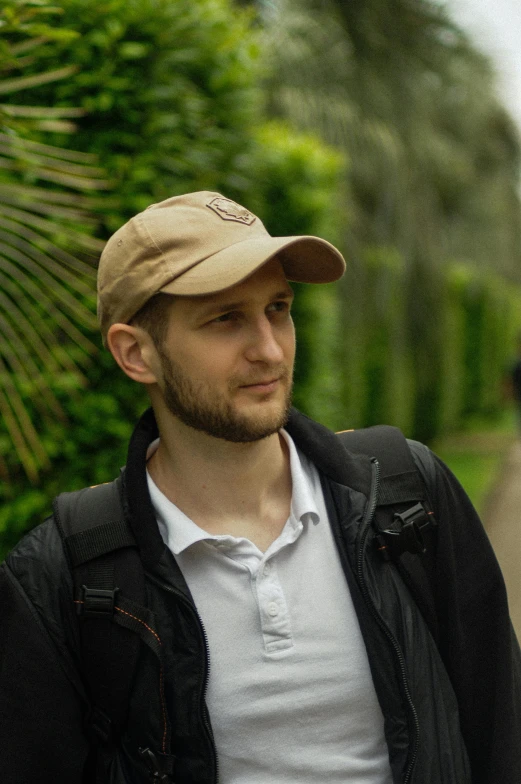 a man is standing outside while looking away