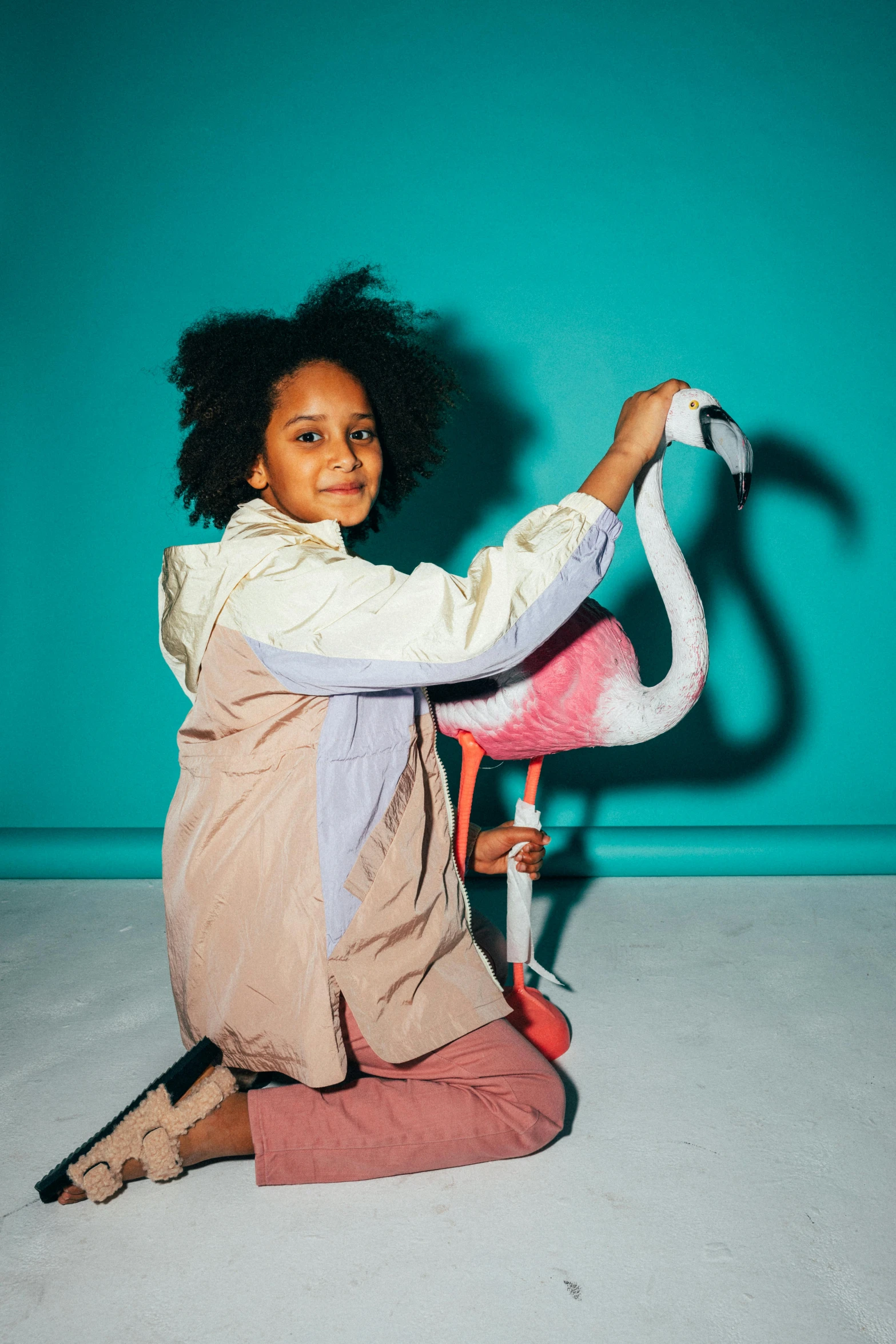 a girl sitting on the ground with her arms outstretched