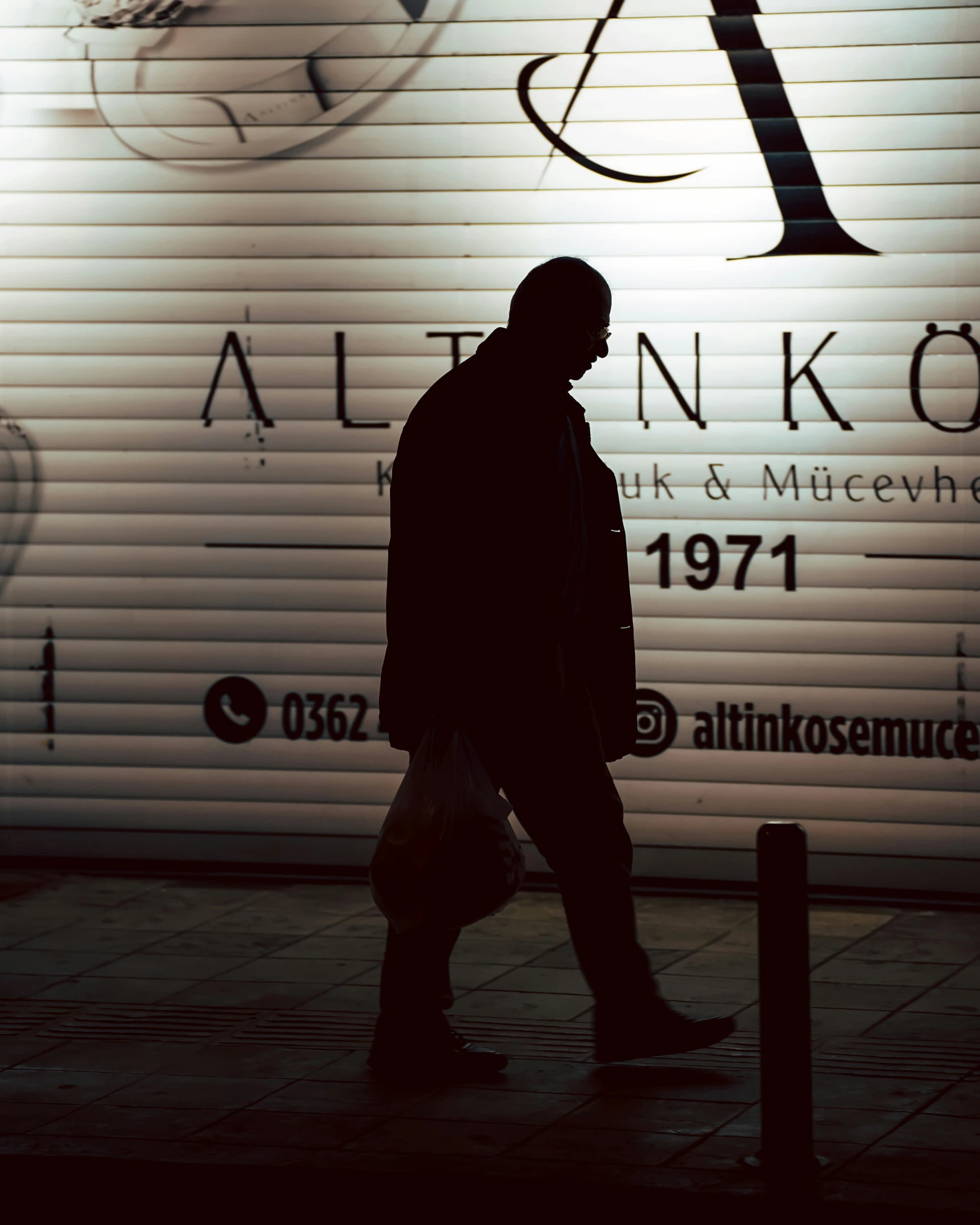 a person walks in front of an advertising wall