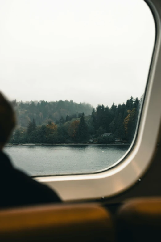 a view from inside an airplane looking out at the lake