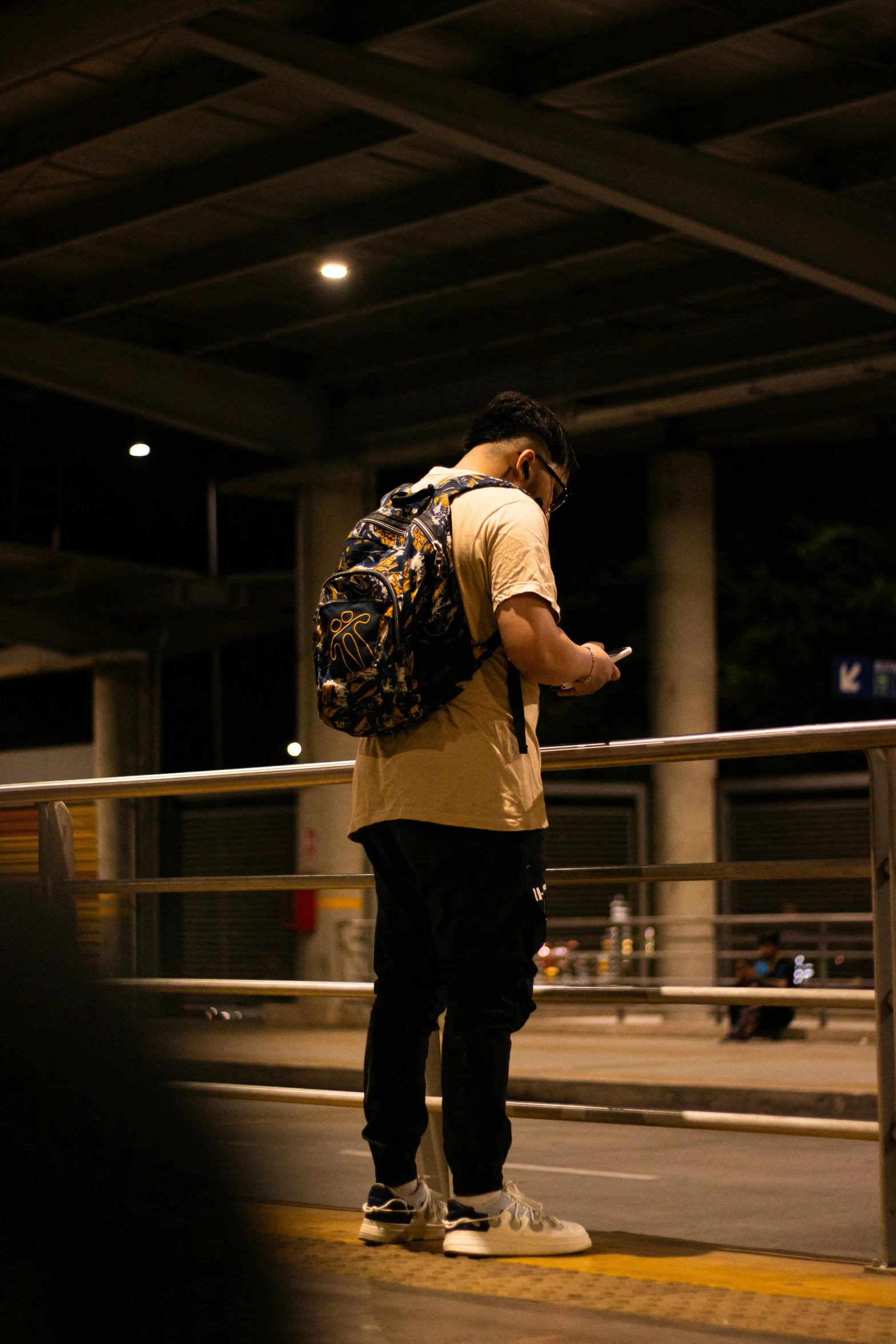 a man with backpack looking at his phone