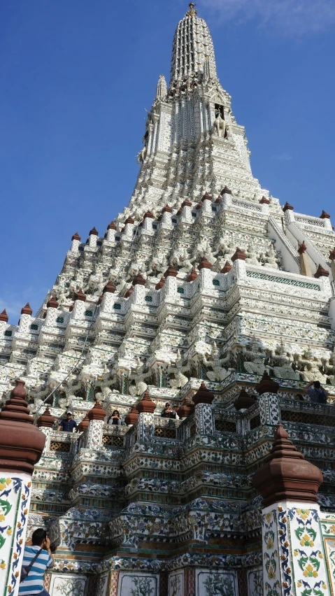 a very elaborate looking tower with two people walking by