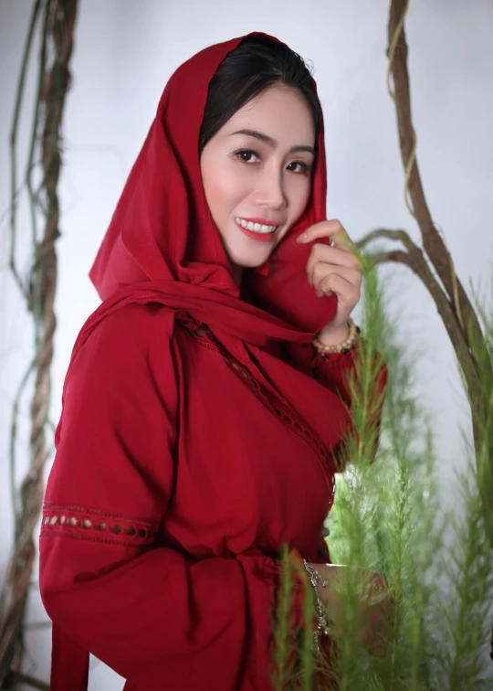 a beautiful young lady posing in red dress