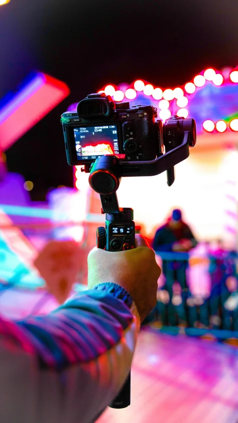 a person holding a video camera in their hand