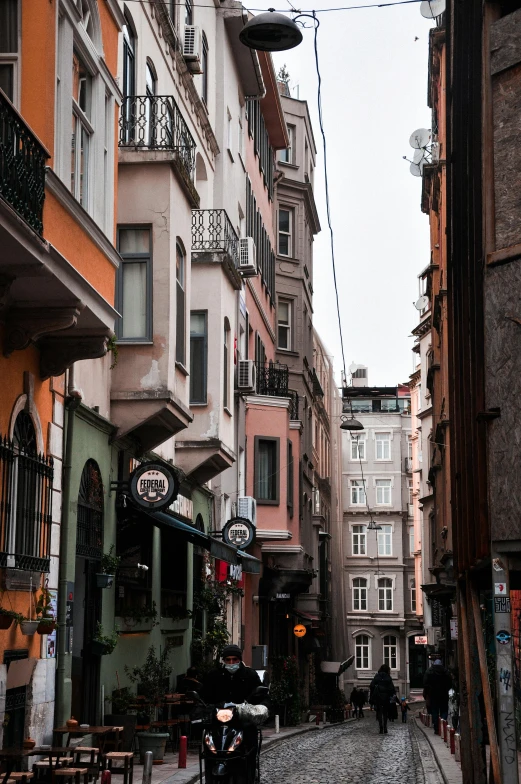 people walk down an empty city street