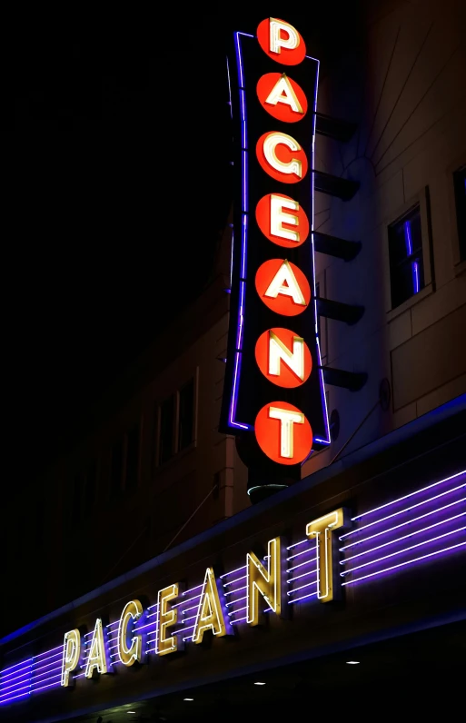 a close up of a neon sign for a theater