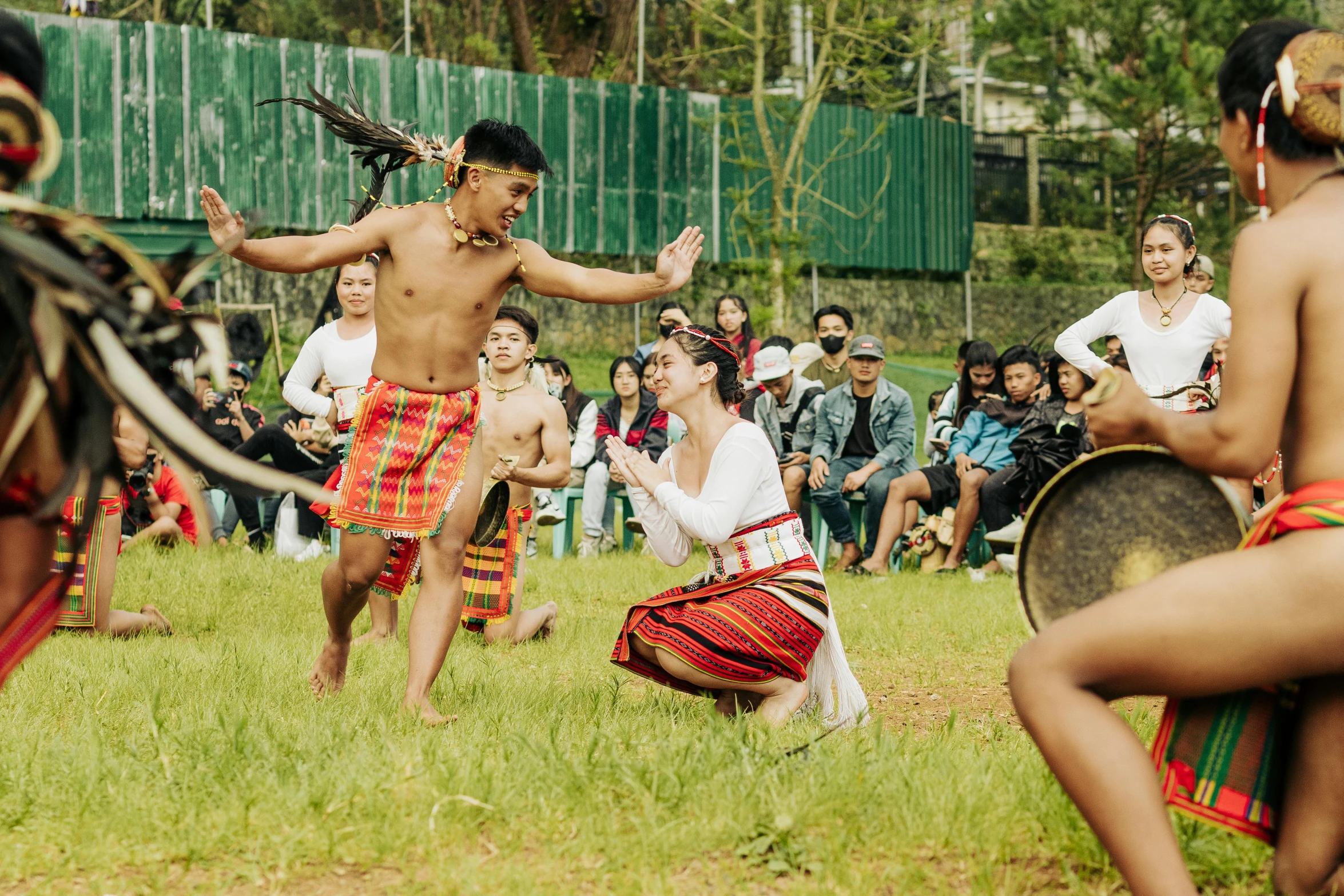 men wearing native clothing perform a traditional dance