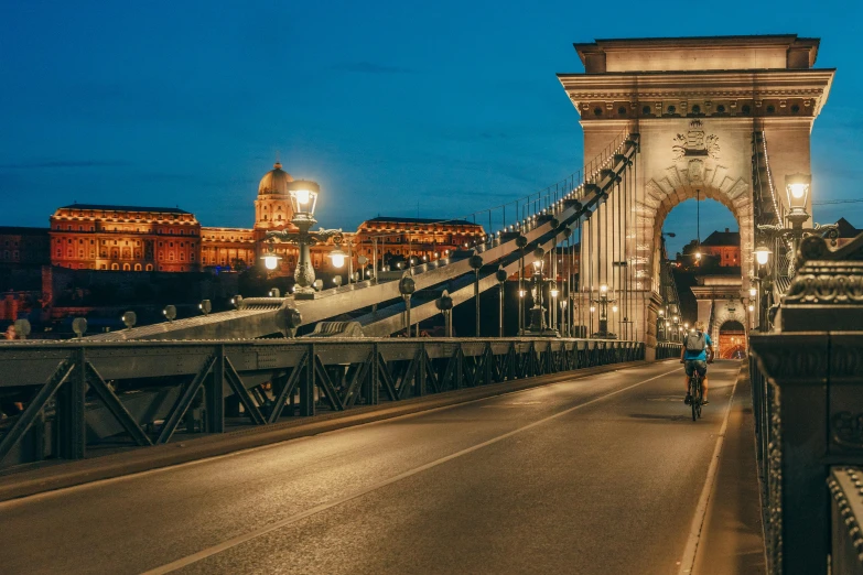 a man riding his bike over the top of a bridge